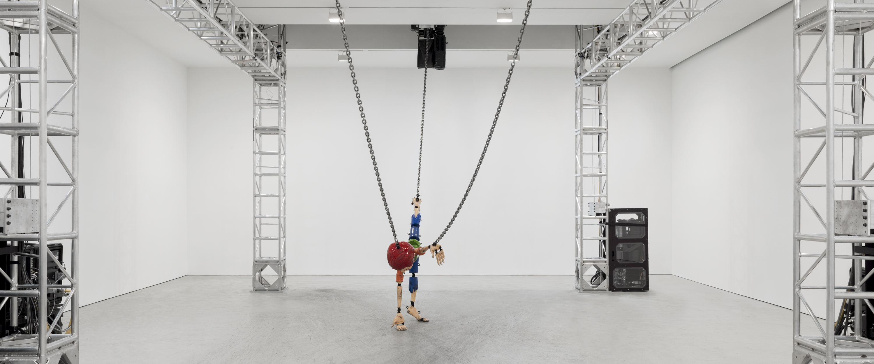 Jordan Wilson's terrifying installation of a Chucky-like dummy is suspended on chains and dragged around the gallery by a large mechanized gantry, as the current show at David Zwirner Chelsea. 