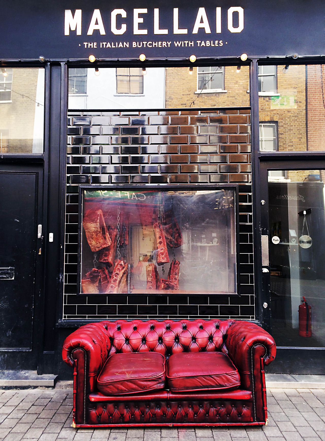 The iconic storefront of Macellaio's Italian butcher restaurant in Exmouth Market. The restaurant is divided into two sections that may be crossed in between once inside: a seafood half and a red meat half. 