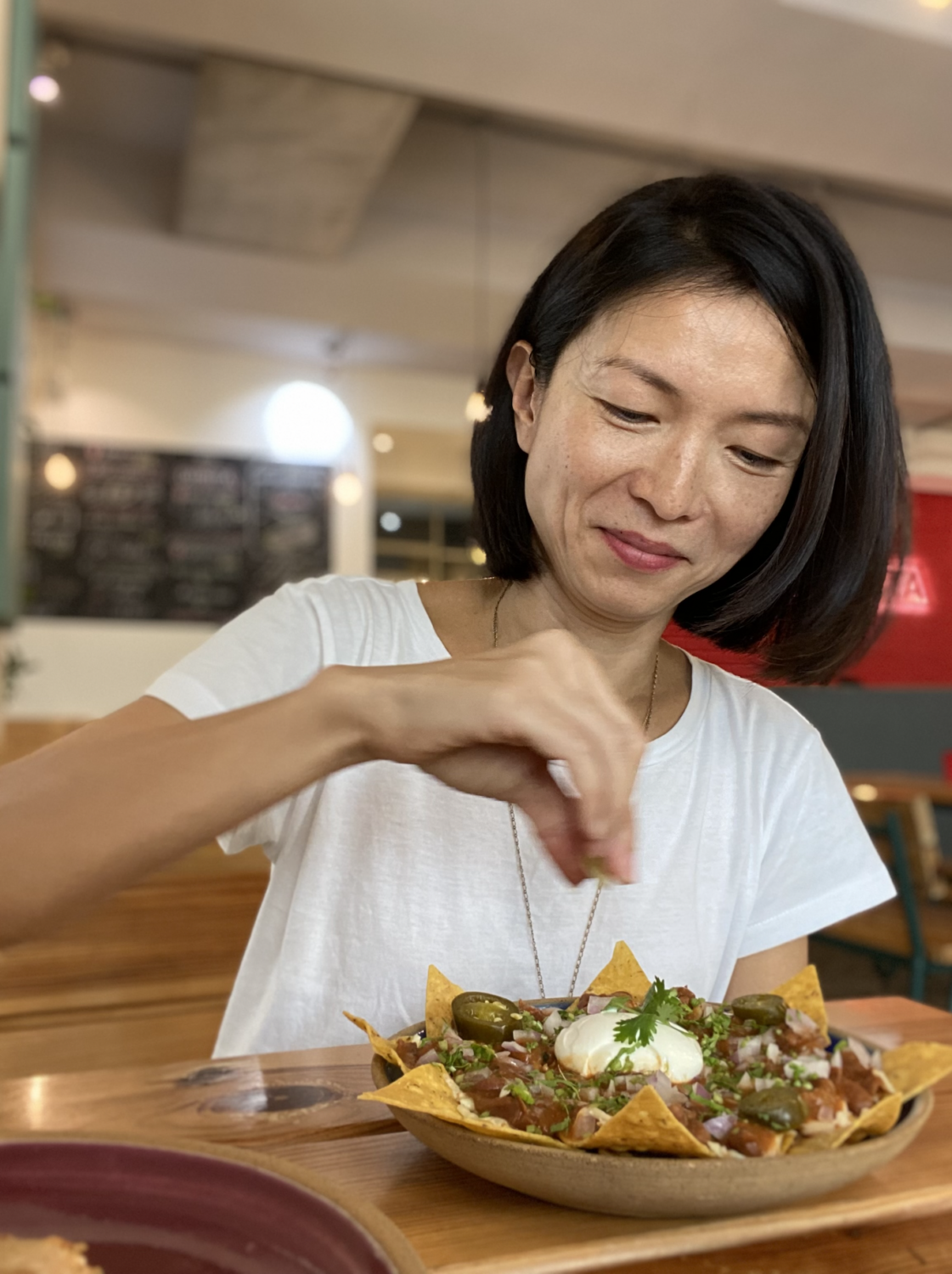 Chef Candice Lock squeezes lime over nachos